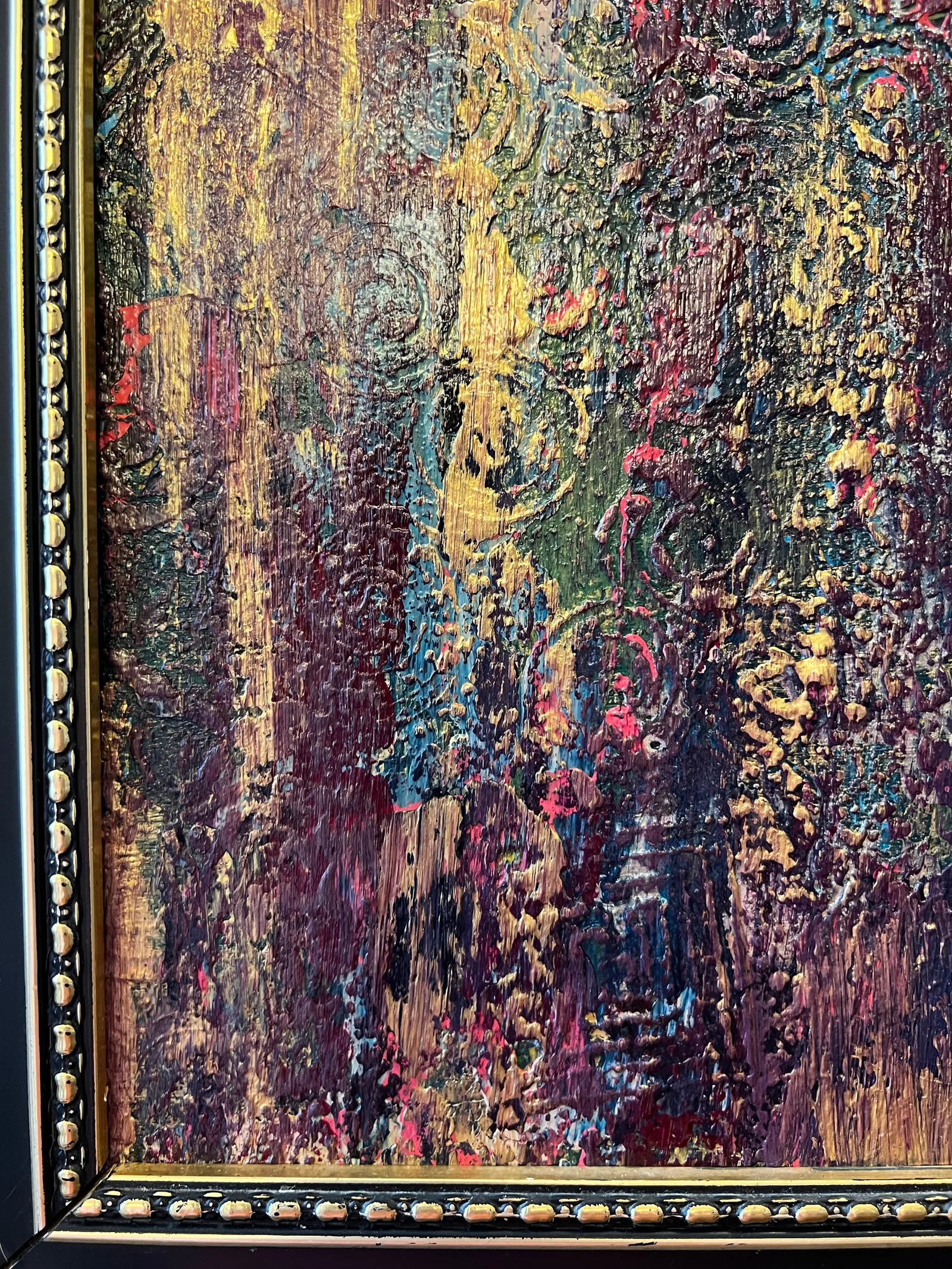 Close-up view of the dimensional gold, plum, teal, and coral details beside the black-and-gold frame of Embers Through the Rain.