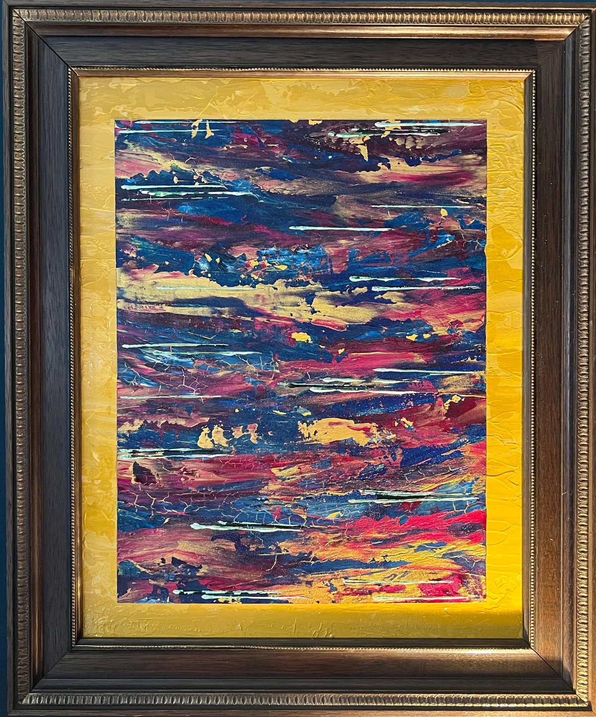 Fractured Horizons, a textured red, blue, gold, and pale green abstract painting presented within a bright yellow mount and ornate brown-and-gold frame.