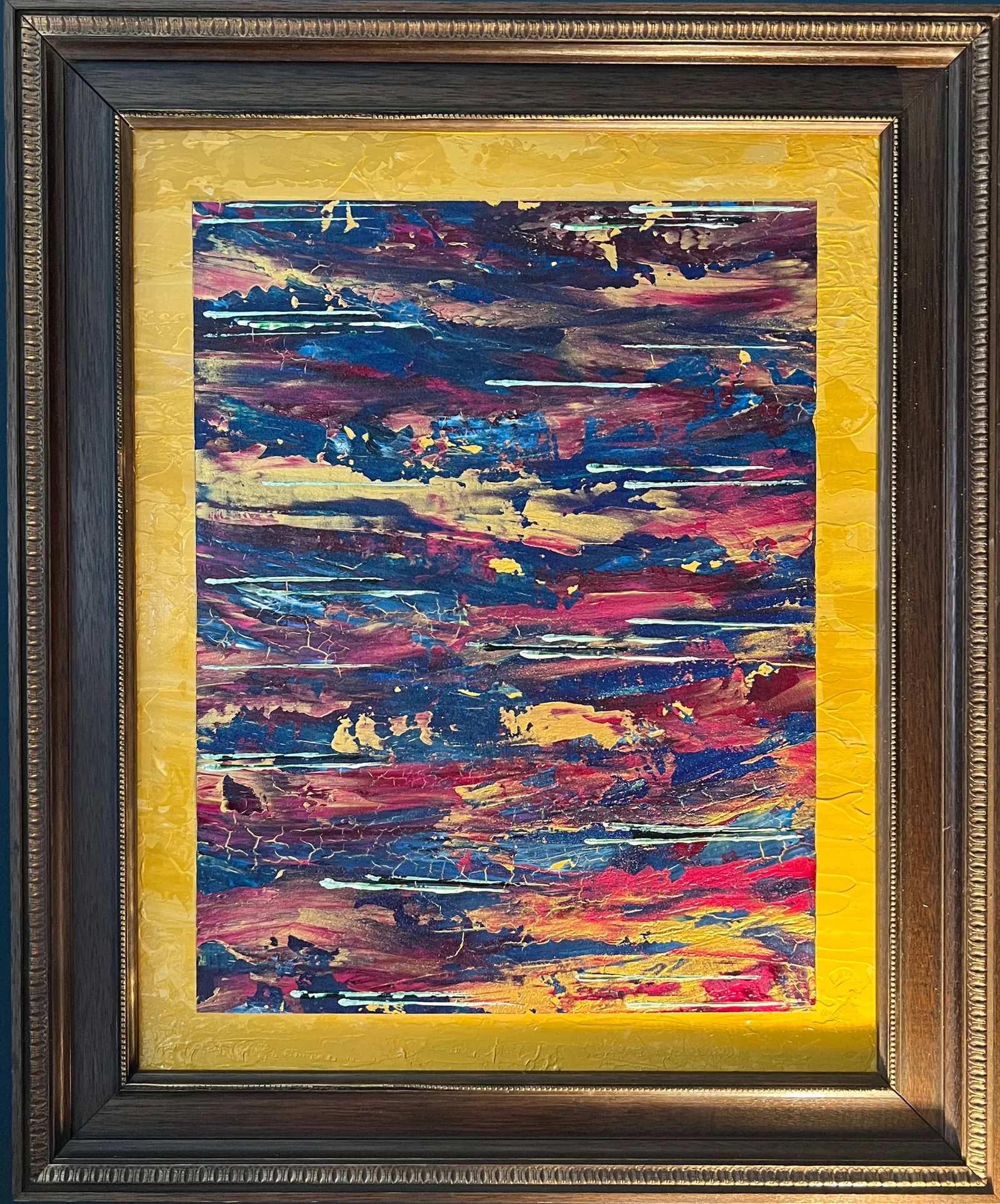 Fractured Horizons, a textured red, blue, gold, and pale green abstract painting presented within a bright yellow mount and ornate brown-and-gold frame.
