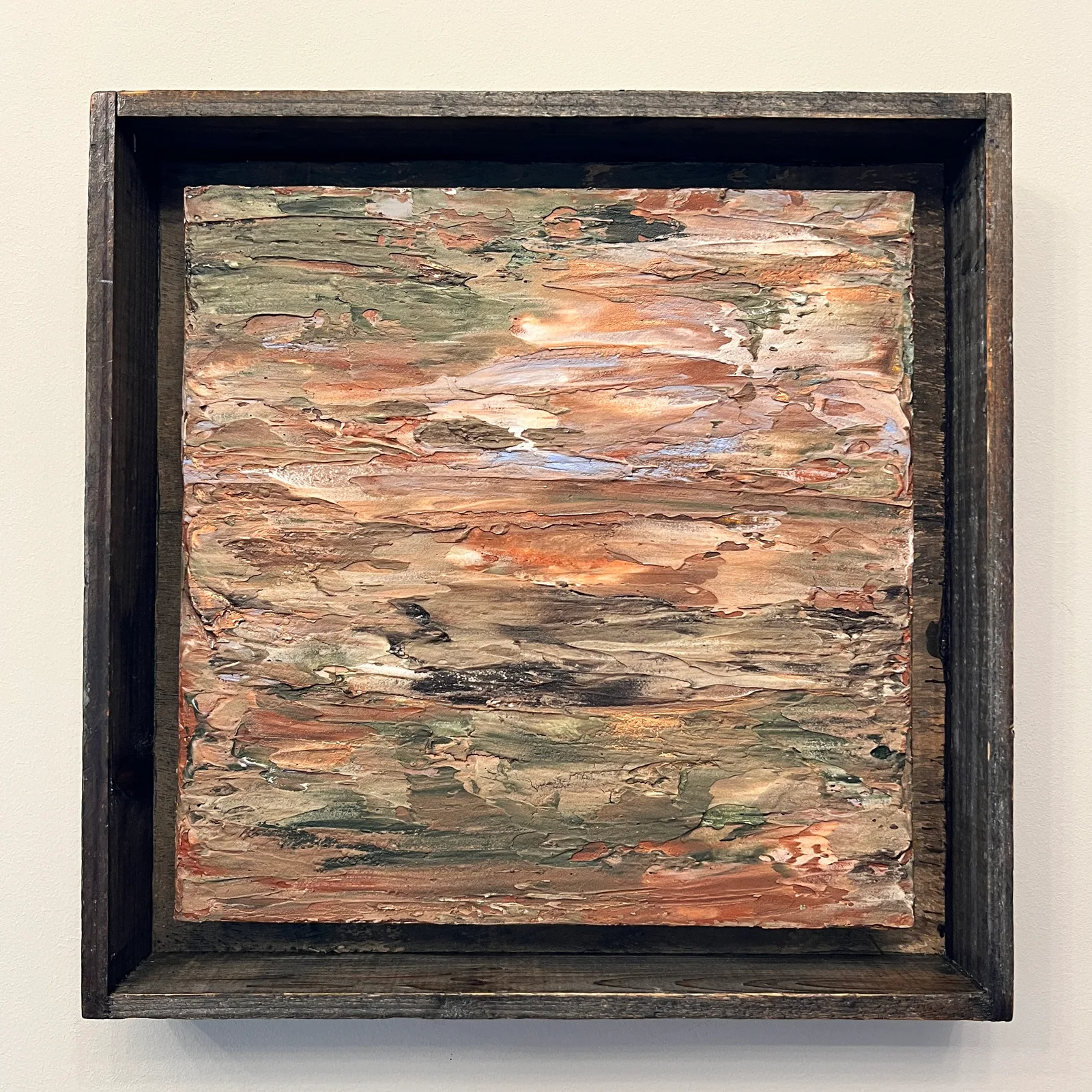 Georgia Clay, a textured abstract painting in terracotta, green and pale blue in a dark wooden frame.