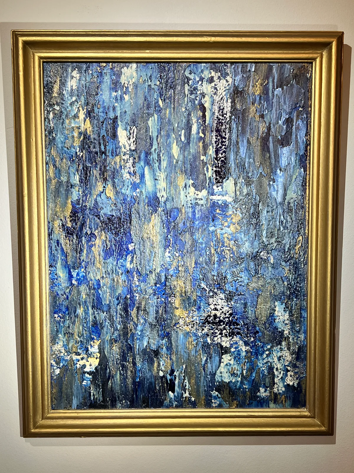 Barefoot Blue Jean Nights, a blue and gold abstract painting in a gold frame against a white background.