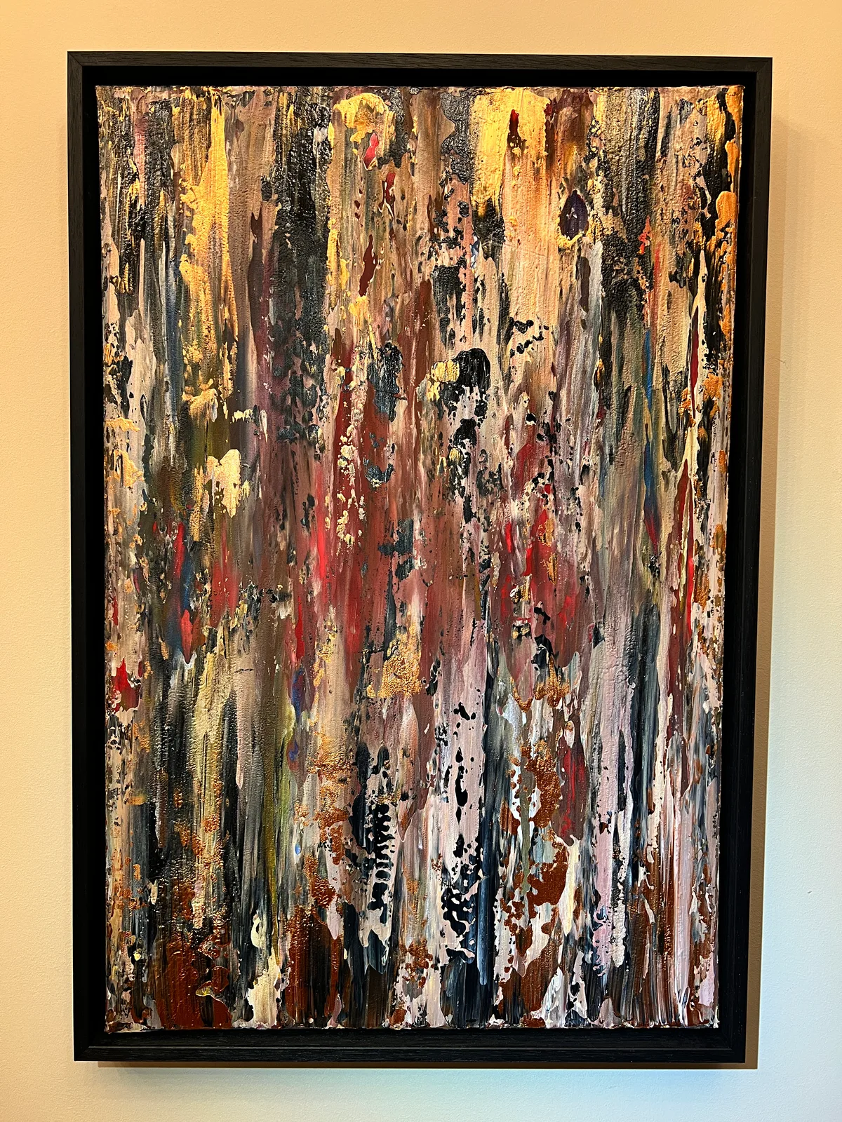 On Safari, a textured abstract painting in earthy brown, pink, black and gold in a black shadow mount.