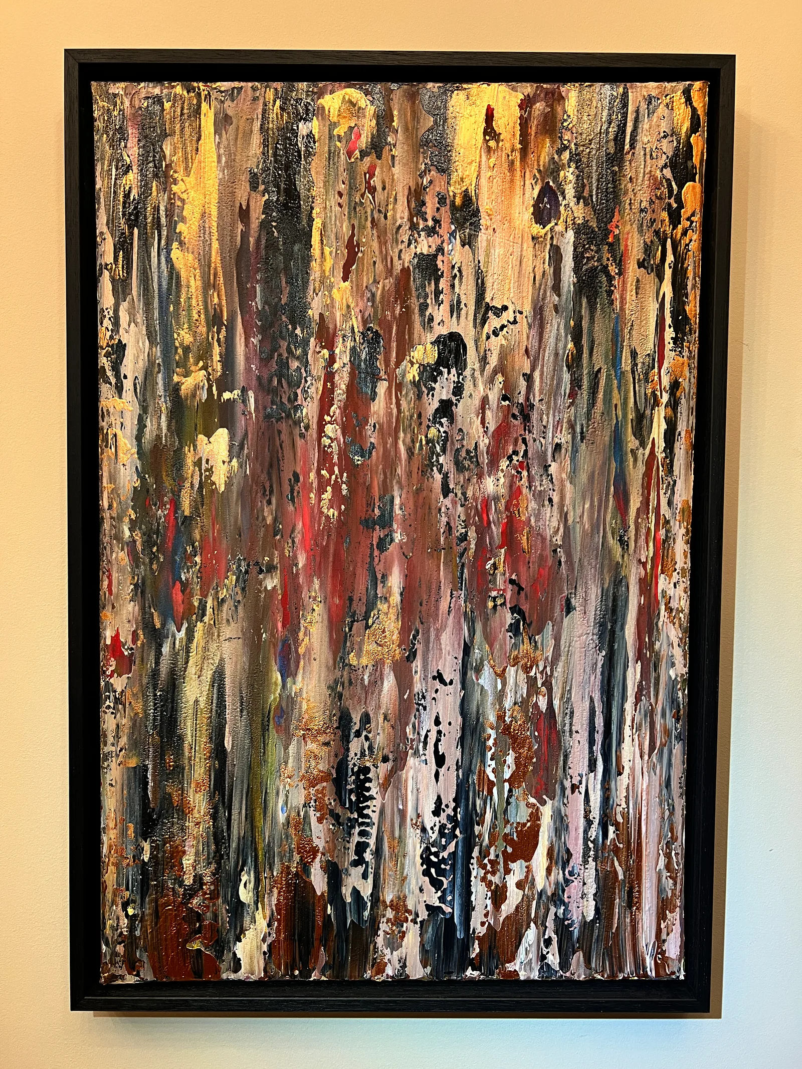On Safari, a textured abstract painting in earthy brown, pink, black and gold in a black shadow mount.